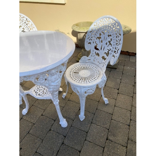 368 - A CAST IRON GARDEN TABLE WITH TWO ALLOY GARDEN CHAIRS. The chairs with nice openwork medallion backr... 