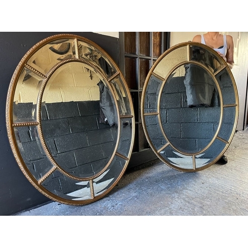 38 - A PAIR OF EXCELLENT QUALITY LARGE GILT OVER MIRRORS, each with central bevelled glass oval panel sur... 