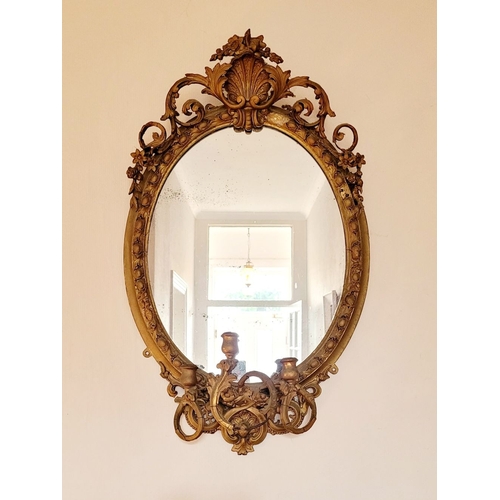 42 - A BEAUTIFUL IRISH 19TH CENTURY GILT OVAL WALL MIRROR, the oval frame with gadrooned edge is mounted ... 