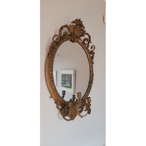 42 - A BEAUTIFUL IRISH 19TH CENTURY GILT OVAL WALL MIRROR, the oval frame with gadrooned edge is mounted ... 