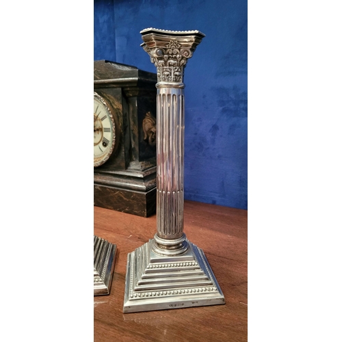 6 - A FINE PAIR OF SILVER CORINTHIAN COLUMN CANDLESTICKS, elegant pair with square graduated step base w... 