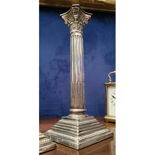 6 - A FINE PAIR OF SILVER CORINTHIAN COLUMN CANDLESTICKS, elegant pair with square graduated step base w... 