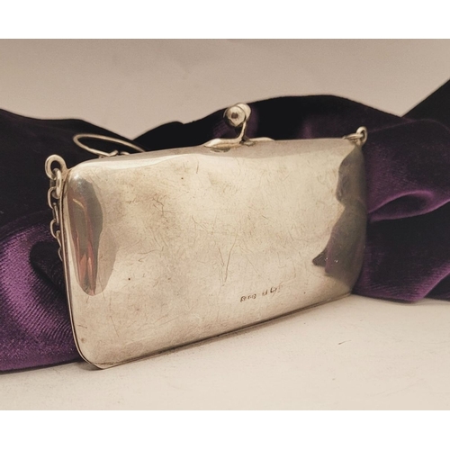 65 - AN EARLY 20TH CENTURY SILVER CLUTCH PURSE, the rounded rectangular silver body has a ball clasp that... 