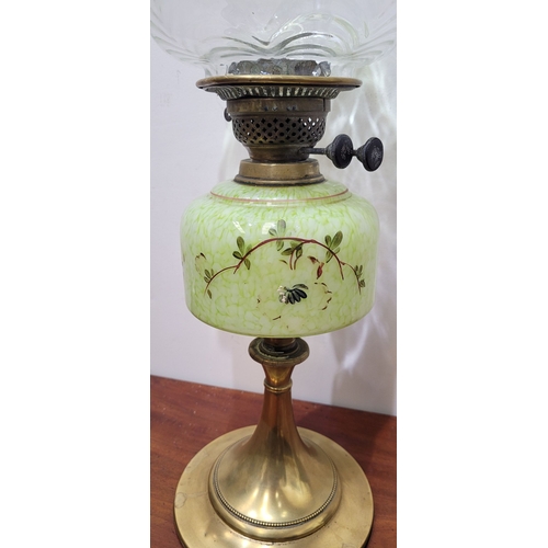 67 - A LATE 19TH CENTURY BRASS BASED OIL LAMP, the large lamp is on a circular brass base and column, wit... 