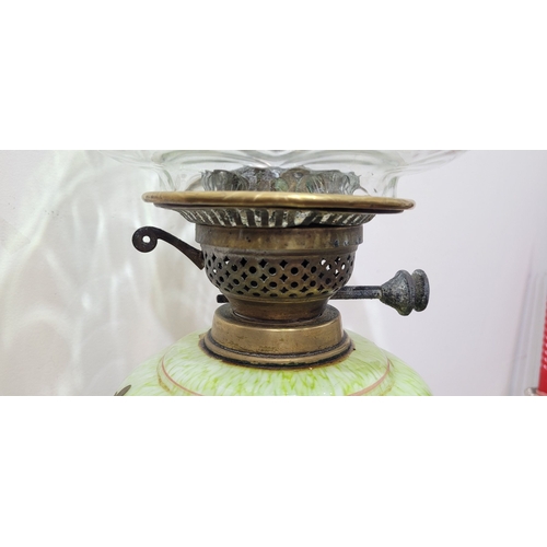 67 - A LATE 19TH CENTURY BRASS BASED OIL LAMP, the large lamp is on a circular brass base and column, wit... 