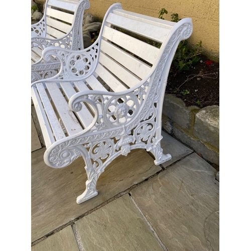 77 - A PAIR OF CAST IRON GARDEN BENCHES, with wooden splat back, cast iron curved openwork supports with ... 