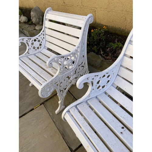 77 - A PAIR OF CAST IRON GARDEN BENCHES, with wooden splat back, cast iron curved openwork supports with ... 