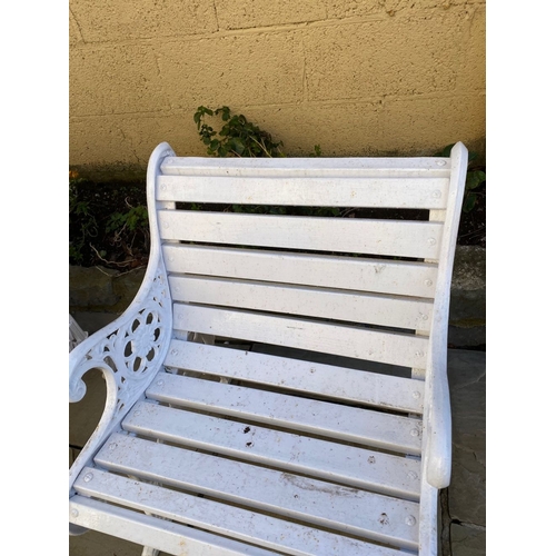 77 - A PAIR OF CAST IRON GARDEN BENCHES, with wooden splat back, cast iron curved openwork supports with ... 