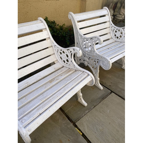 77 - A PAIR OF CAST IRON GARDEN BENCHES, with wooden splat back, cast iron curved openwork supports with ... 