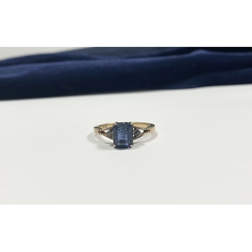 80 - A PRETTY 9CT GOLD PLATED SAPPHIRE RING, large emerald cut sapphire in claw setting, flanked by marca... 