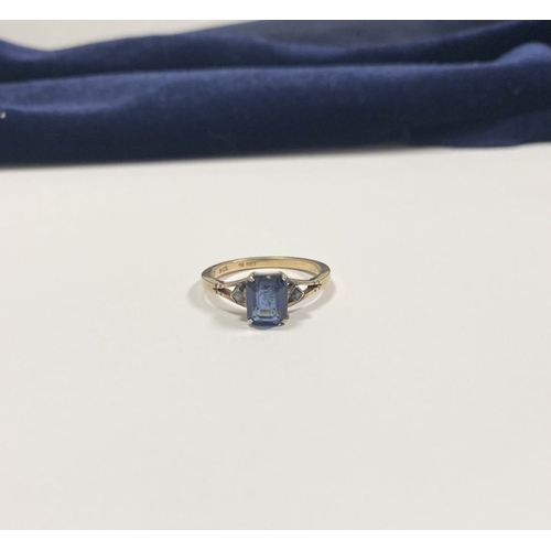 80 - A PRETTY 9CT GOLD PLATED SAPPHIRE RING, large emerald cut sapphire in claw setting, flanked by marca... 