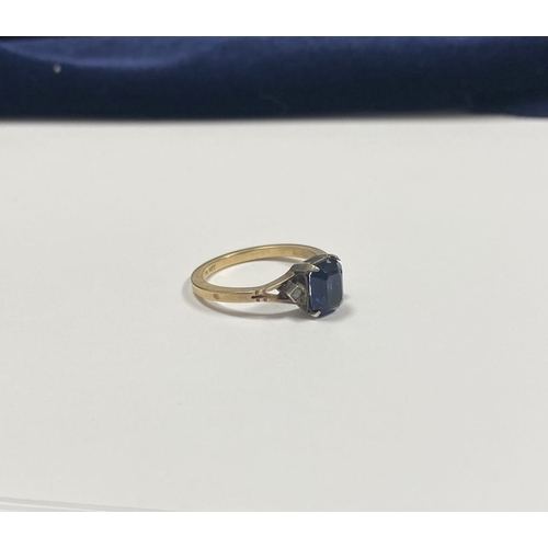 80 - A PRETTY 9CT GOLD PLATED SAPPHIRE RING, large emerald cut sapphire in claw setting, flanked by marca... 