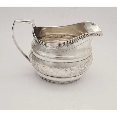 9 - A GOOD GEORGE III BRIGHT CUT CORK SILVER CREAM JUG, by S Greene Cork c.1800. With reeded border to t... 