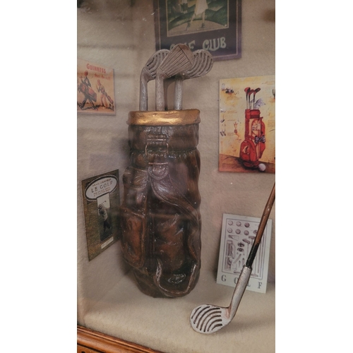 182 - A FRAMED GOLF SHADOWBOX, filled with miniature ornamental items relating to the sport of golf. Conte... 