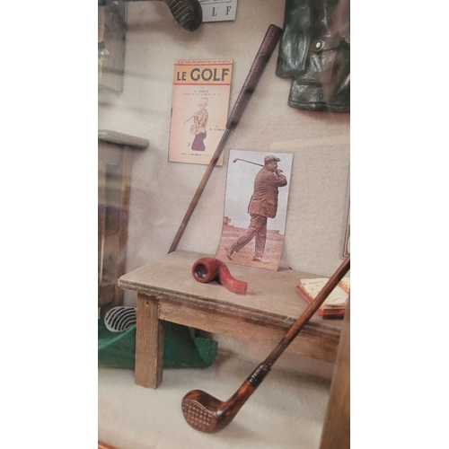 182 - A FRAMED GOLF SHADOWBOX, filled with miniature ornamental items relating to the sport of golf. Conte... 