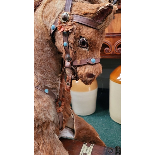 183 - A VINTAGE EARLY 20TH CENTURY AYRES HIDE COVERED ROCKING HORSE, the hide/hair covered horses rarer th... 