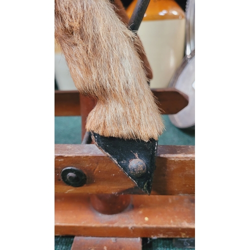 183 - A VINTAGE EARLY 20TH CENTURY AYRES HIDE COVERED ROCKING HORSE, the hide/hair covered horses rarer th... 