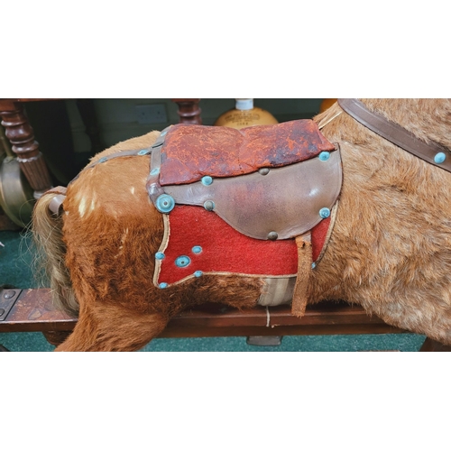 183 - A VINTAGE EARLY 20TH CENTURY AYRES HIDE COVERED ROCKING HORSE, the hide/hair covered horses rarer th... 
