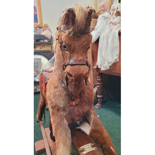183 - A VINTAGE EARLY 20TH CENTURY AYRES HIDE COVERED ROCKING HORSE, the hide/hair covered horses rarer th... 