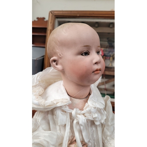 184 - A VINTAGE GERMAN MADE BISQUE COMPOSITE JOINTED DOLL; the delicately created facial features of this ... 