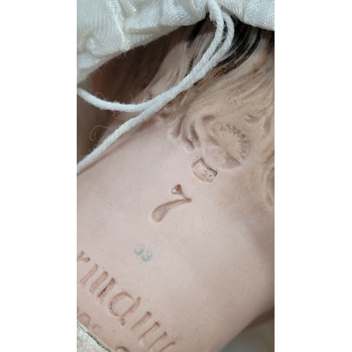 184 - A VINTAGE GERMAN MADE BISQUE COMPOSITE JOINTED DOLL; the delicately created facial features of this ... 