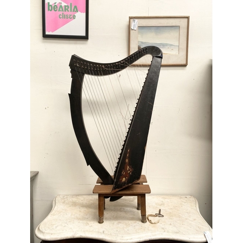 185 - A VINTAGE HARDWOOD IRISH HARP, 28 string harp. Complete with hardwood stand with brass capped feet. ... 