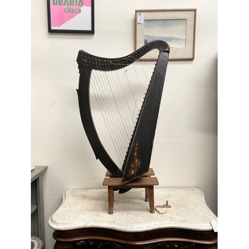 185 - A VINTAGE HARDWOOD IRISH HARP, 28 string harp. Complete with hardwood stand with brass capped feet. ... 