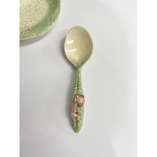 189 - A NEWPORT POTTERY CLARICE CLIFF DISH & SPOON, pink flower dish and spoon, the dish with Makers marks... 