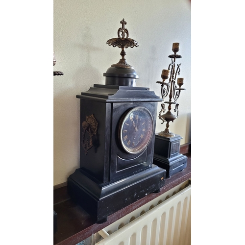 194 - A HEAVY BLACK SLATE MANTEL CLOCK WITH CANDELABRA, the candelabra with three candle holders is decora... 