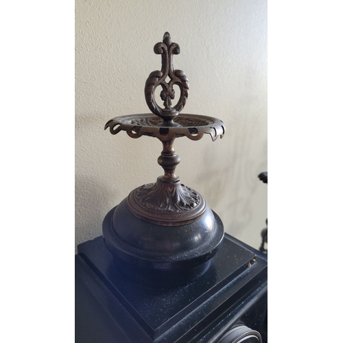 194 - A HEAVY BLACK SLATE MANTEL CLOCK WITH CANDELABRA, the candelabra with three candle holders is decora... 