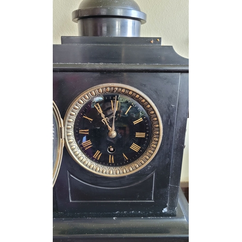 194 - A HEAVY BLACK SLATE MANTEL CLOCK WITH CANDELABRA, the candelabra with three candle holders is decora... 