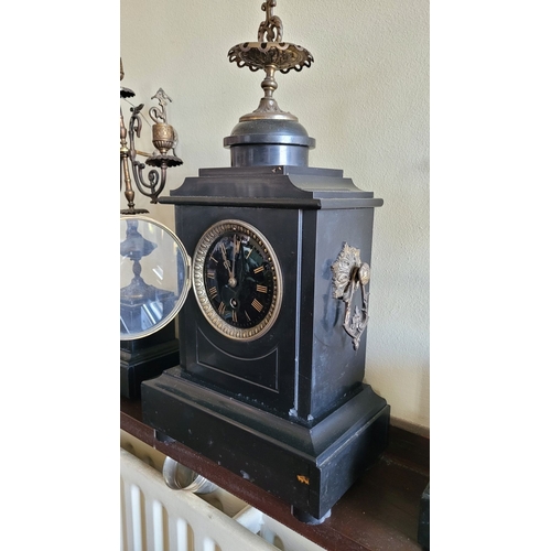 194 - A HEAVY BLACK SLATE MANTEL CLOCK WITH CANDELABRA, the candelabra with three candle holders is decora... 
