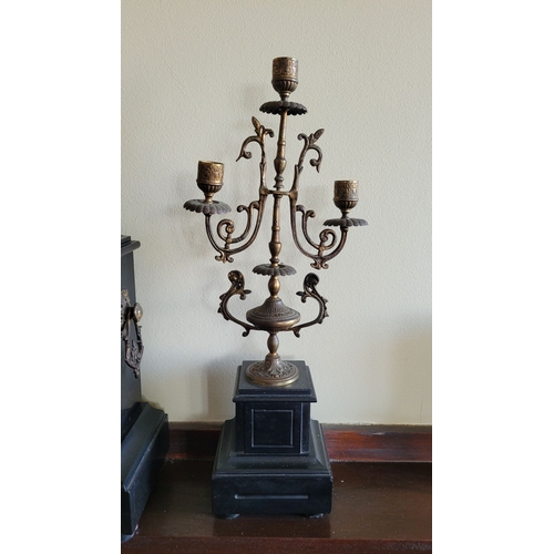 194 - A HEAVY BLACK SLATE MANTEL CLOCK WITH CANDELABRA, the candelabra with three candle holders is decora... 