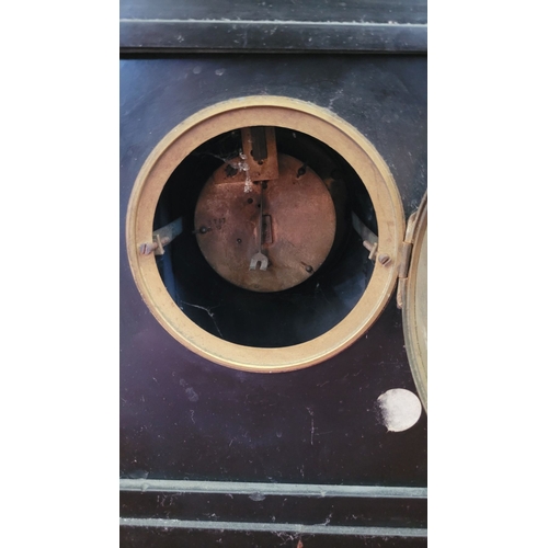 194 - A HEAVY BLACK SLATE MANTEL CLOCK WITH CANDELABRA, the candelabra with three candle holders is decora... 