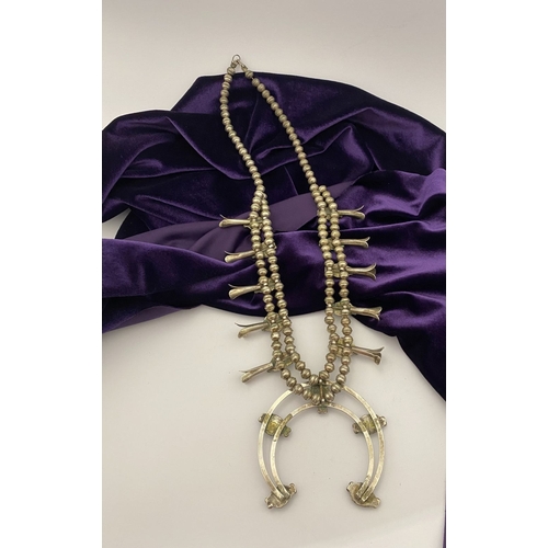 215 - A VINTAGE NAVAJO STERLING SILVER TURQUOISE SQUASH BLOSSOM NECKLACE, with two rows of beads to neckla... 