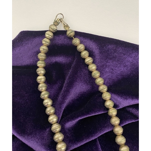 215 - A VINTAGE NAVAJO STERLING SILVER TURQUOISE SQUASH BLOSSOM NECKLACE, with two rows of beads to neckla... 