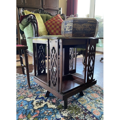 226 - A NEAT SIZED MAHOGANY REVOLVING BOOKCASE, the top with shaped edge and stepped border, above bookcas... 