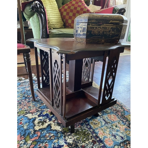 226 - A NEAT SIZED MAHOGANY REVOLVING BOOKCASE, the top with shaped edge and stepped border, above bookcas... 