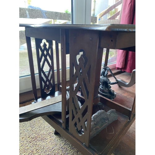 226 - A NEAT SIZED MAHOGANY REVOLVING BOOKCASE, the top with shaped edge and stepped border, above bookcas... 