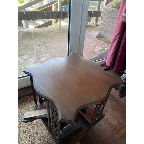 226 - A NEAT SIZED MAHOGANY REVOLVING BOOKCASE, the top with shaped edge and stepped border, above bookcas... 