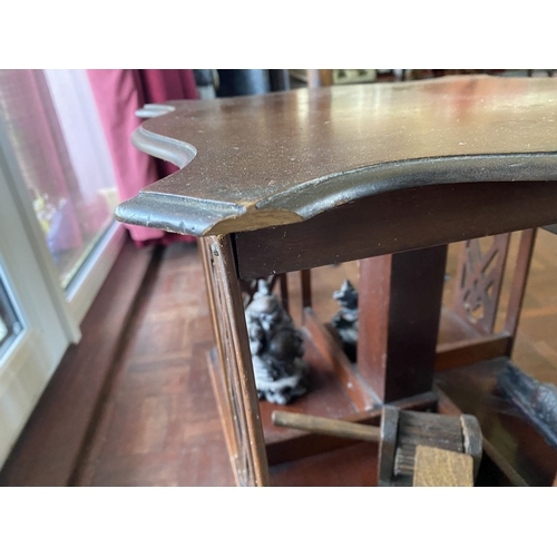 226 - A NEAT SIZED MAHOGANY REVOLVING BOOKCASE, the top with shaped edge and stepped border, above bookcas... 