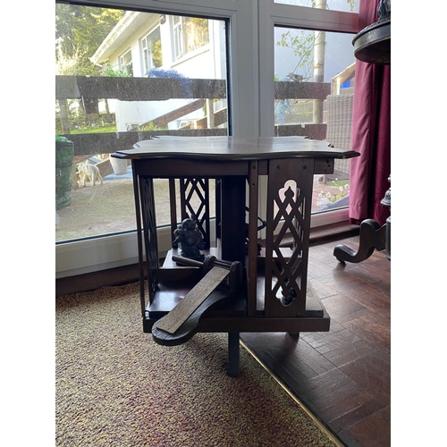 226 - A NEAT SIZED MAHOGANY REVOLVING BOOKCASE, the top with shaped edge and stepped border, above bookcas... 