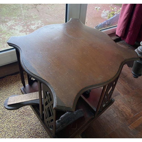 226 - A NEAT SIZED MAHOGANY REVOLVING BOOKCASE, the top with shaped edge and stepped border, above bookcas... 