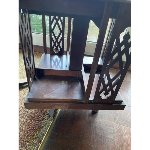 226 - A NEAT SIZED MAHOGANY REVOLVING BOOKCASE, the top with shaped edge and stepped border, above bookcas... 