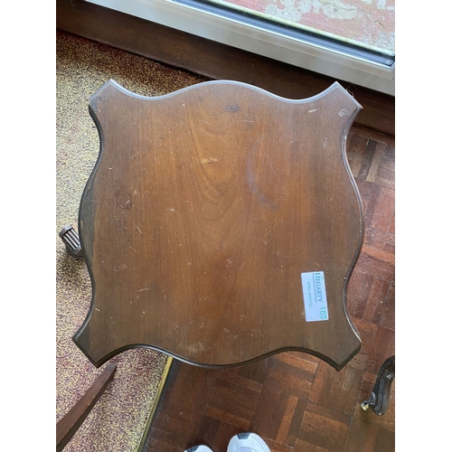 226 - A NEAT SIZED MAHOGANY REVOLVING BOOKCASE, the top with shaped edge and stepped border, above bookcas... 