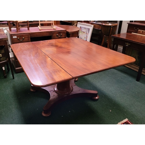 289 - A LARGE IRISH REGENCY MAHOGANY TIP-UP DINING TABLE, the table top made from two pieces of stunning m... 