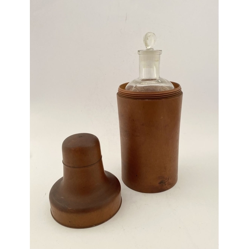 185 - AN ANTIQUE BOXWOOD CASED APOTHECARY/PERFUME BOTTLE, glass bottle with stopper numbered to base. The ... 