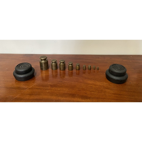 197 - A SET OF BRASS WEIGHTS ALONG WITH CAST IRON WEIGHTS.