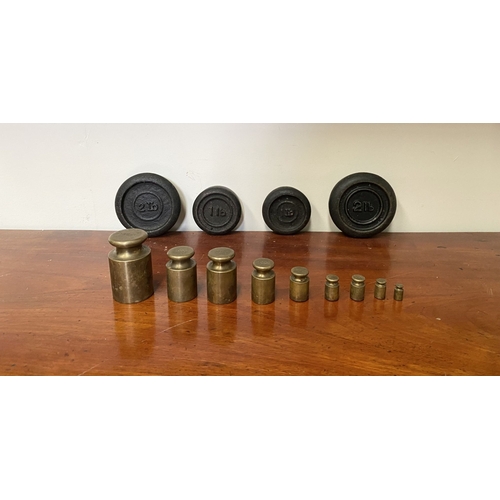 197 - A SET OF BRASS WEIGHTS ALONG WITH CAST IRON WEIGHTS.