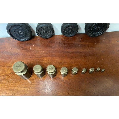 197 - A SET OF BRASS WEIGHTS ALONG WITH CAST IRON WEIGHTS.